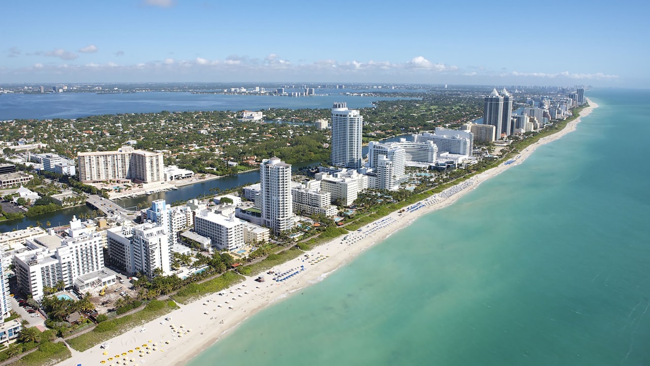 aerial view of city buildings near body of water during daytime