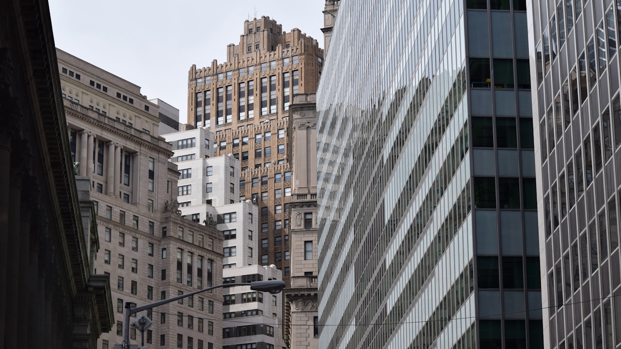 a city street with tall buildings and a traffic light