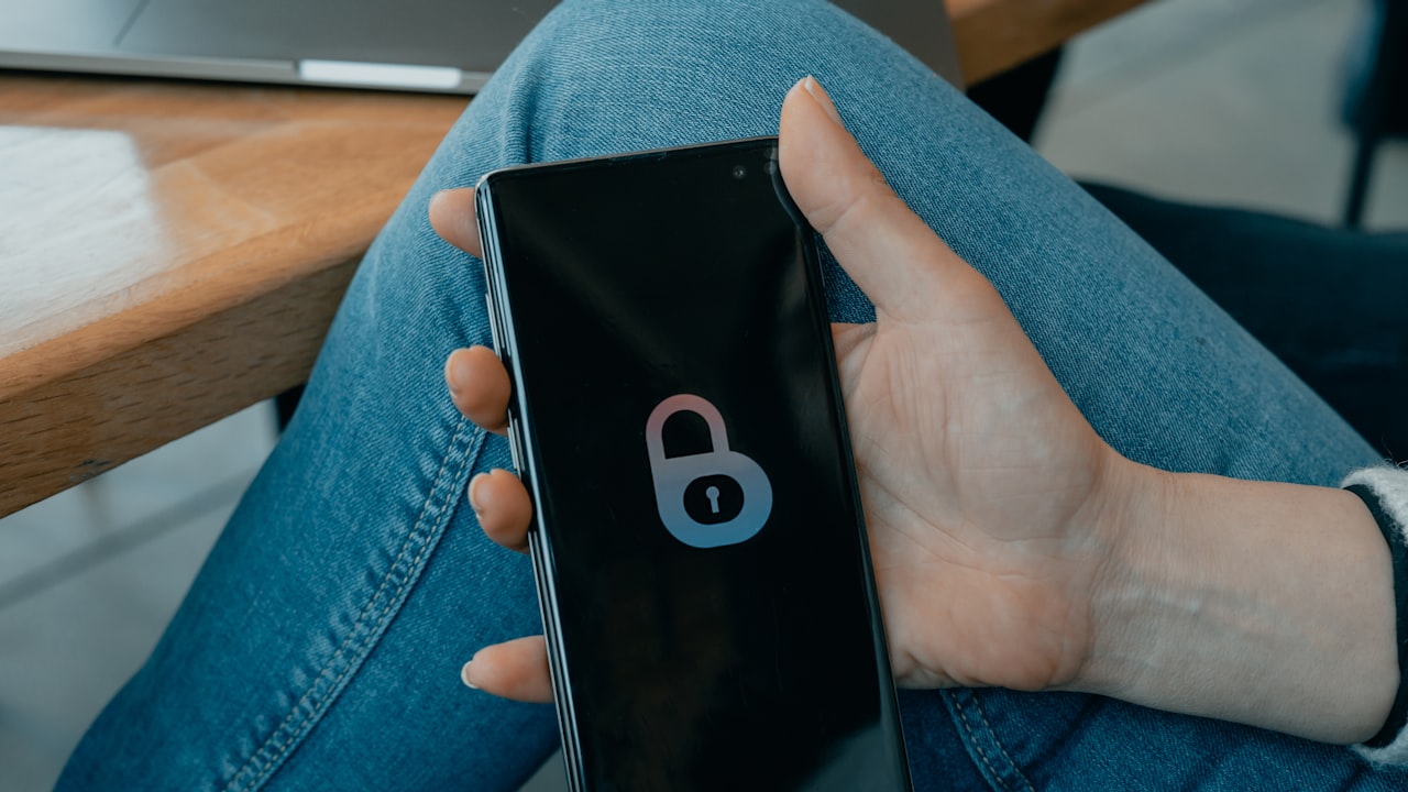 black and white smartphone on persons hand