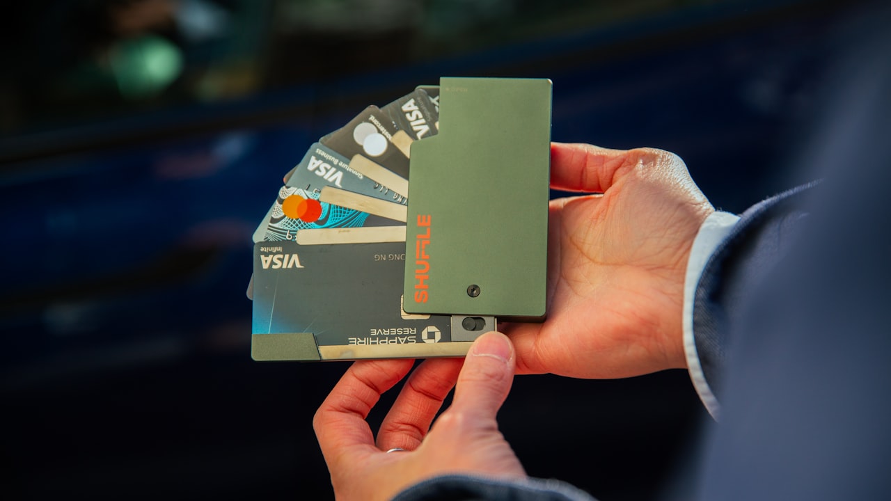 a person holding several credit cards in their hand