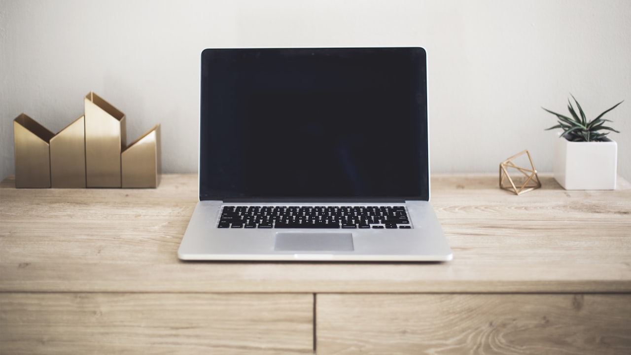 MacBook Pro on top of brown table