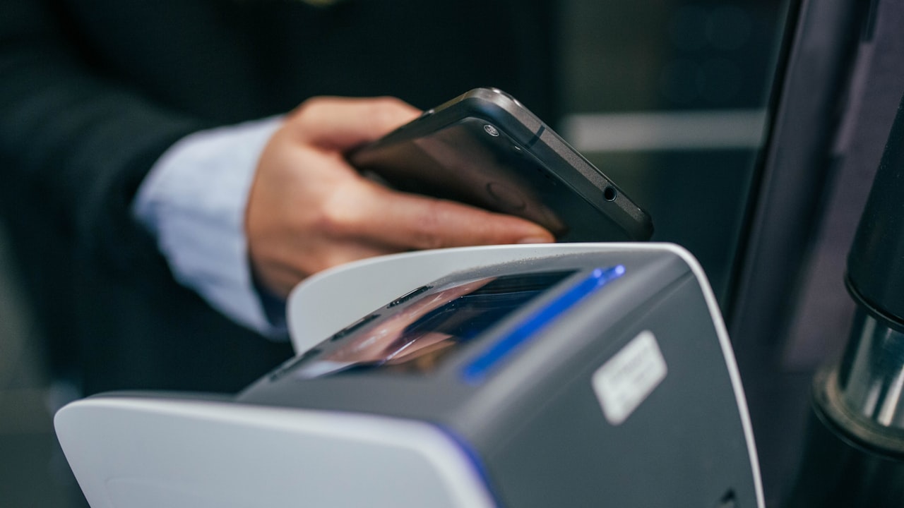 shallow focus photography of person holding smartphone
