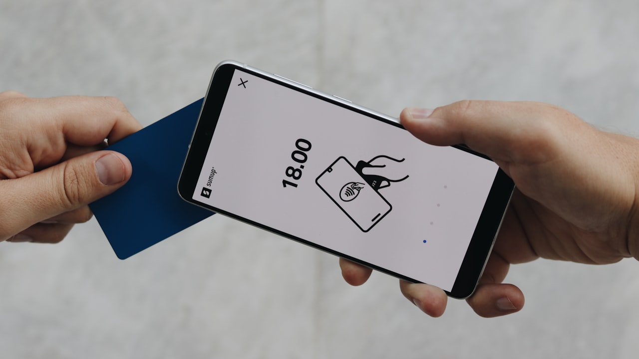 A person holding a cell phone in their hand