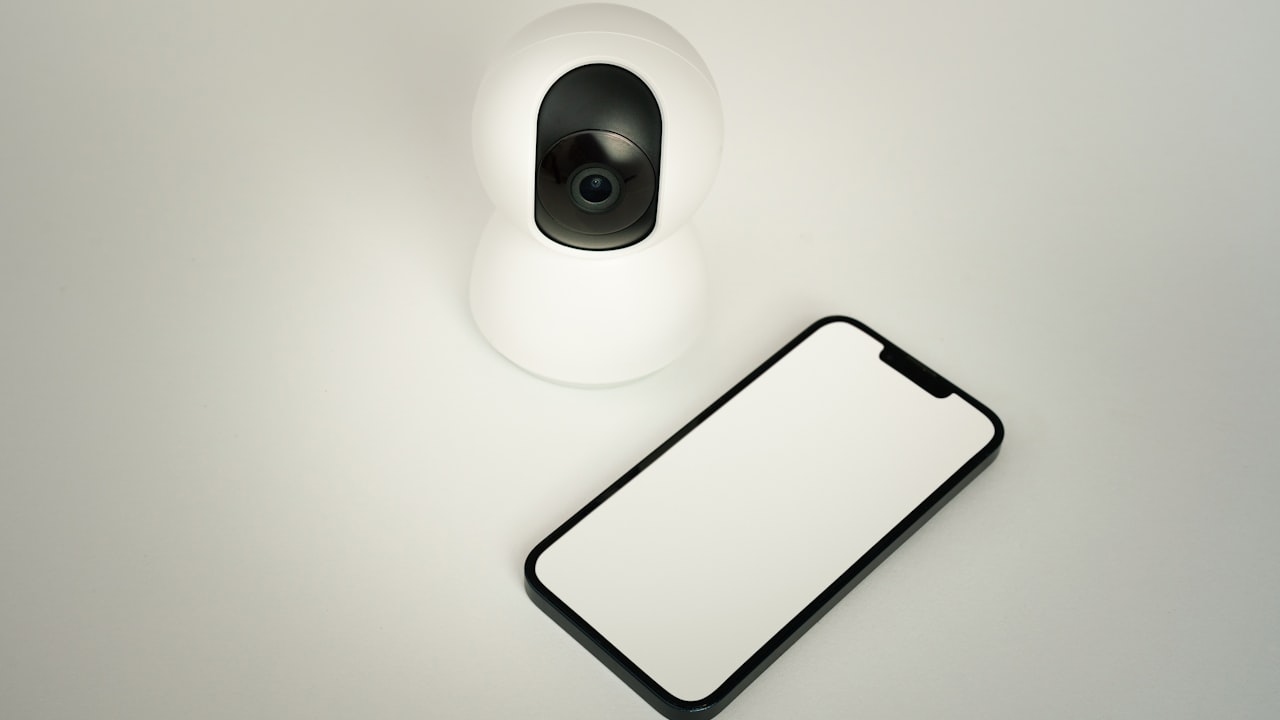 A camera and a cell phone sitting on a table