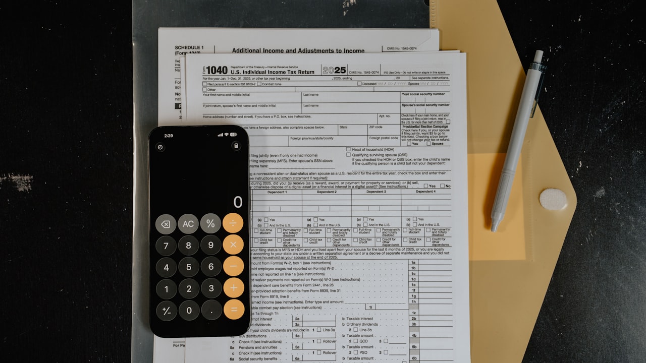 Calculator and pen on tax forms