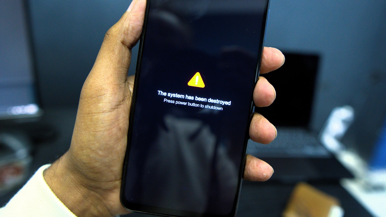Phone shows a system failure warning message.