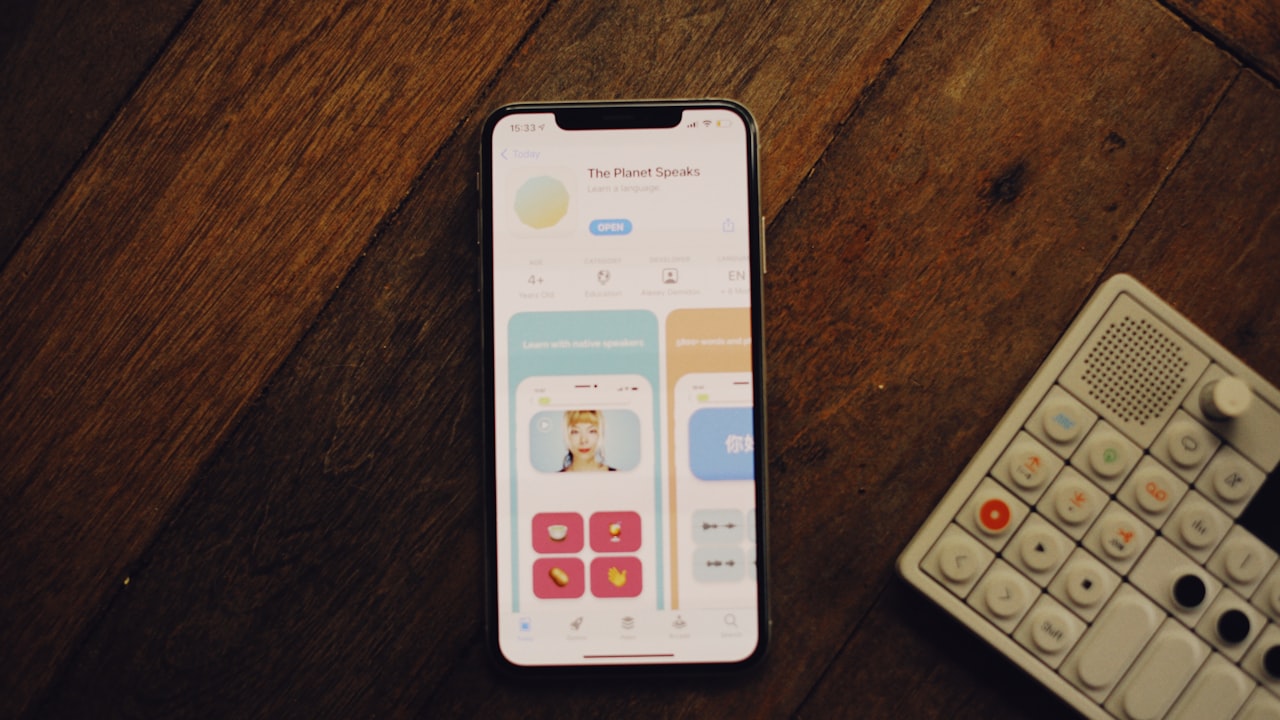a cell phone sitting next to a remote control