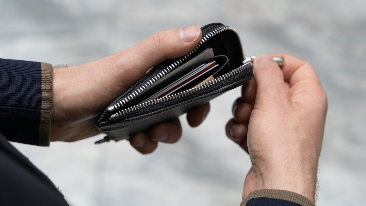 a person holding a wallet in their hand