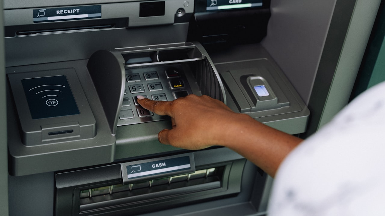 a person using an atm machine to pay money