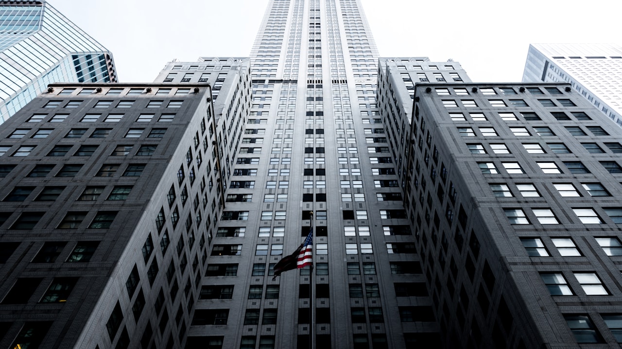 low angle photo of gray concrete high-rise building
