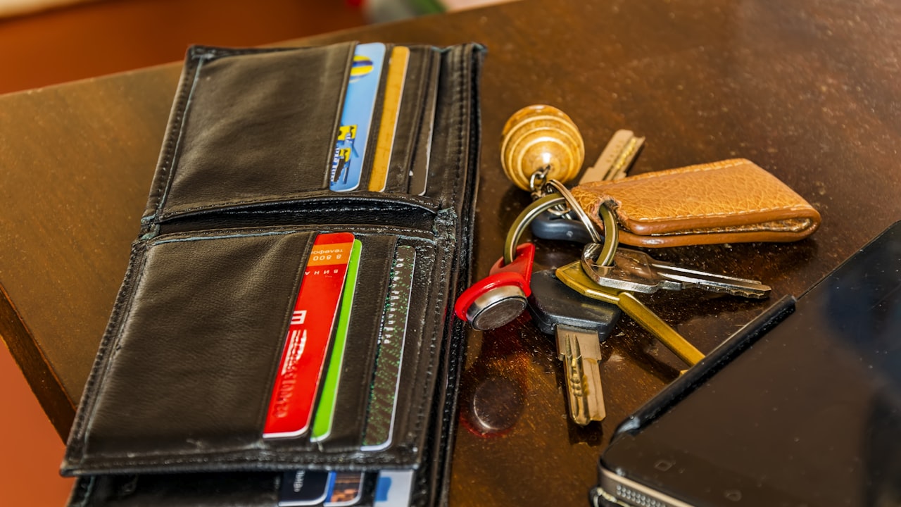a wallet and keys on a table