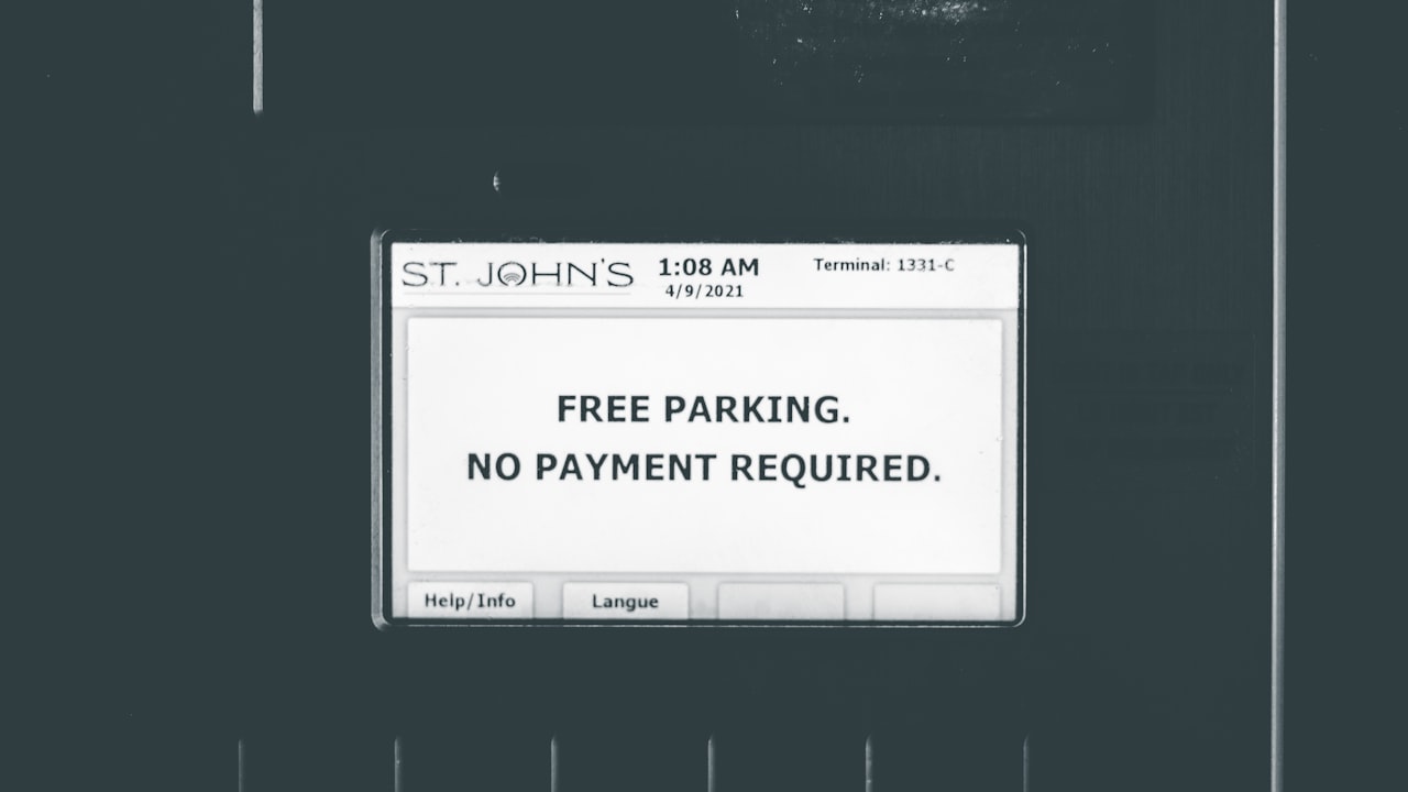 a black and white photo of a parking sign