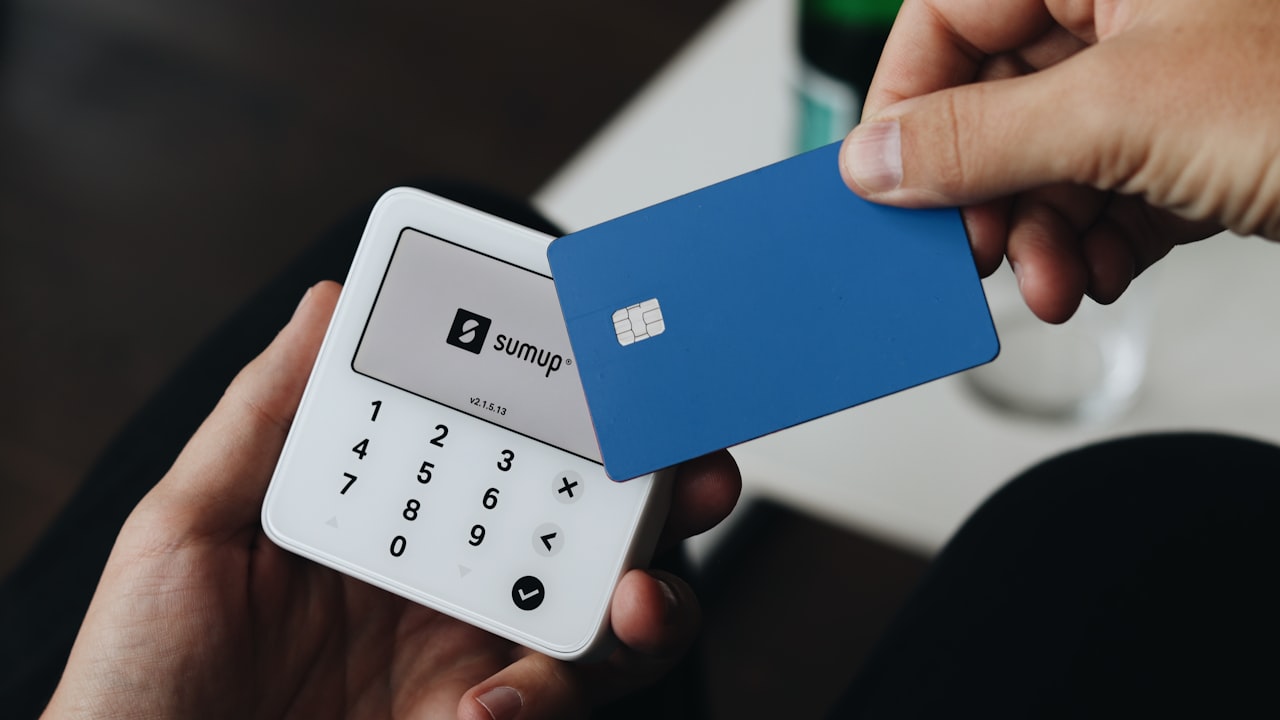 A person holding a credit card in their hand