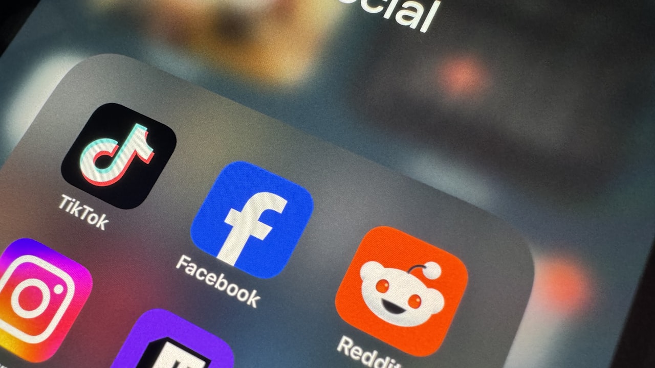 a close up of a cell phone with social icons on it