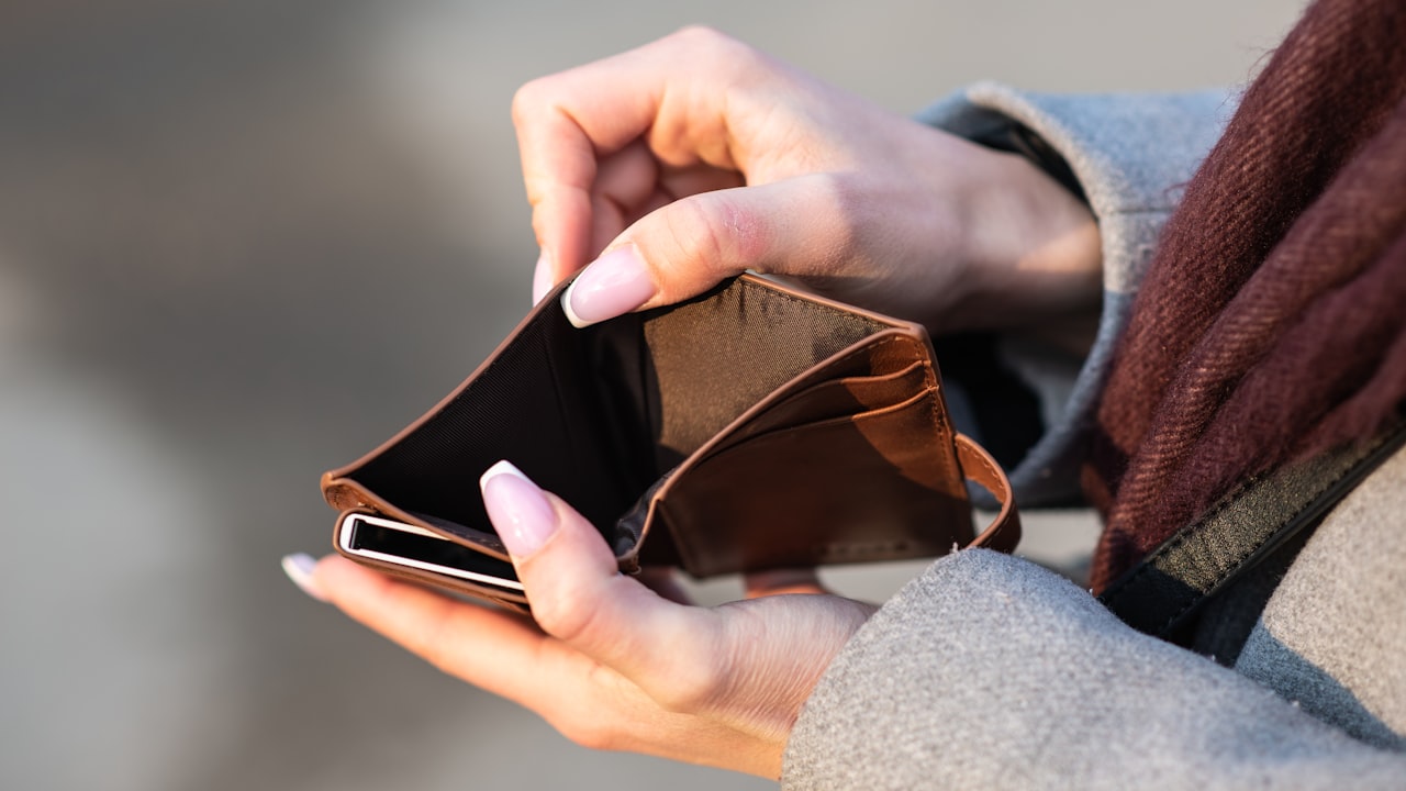 hands holding empty wallet and phone