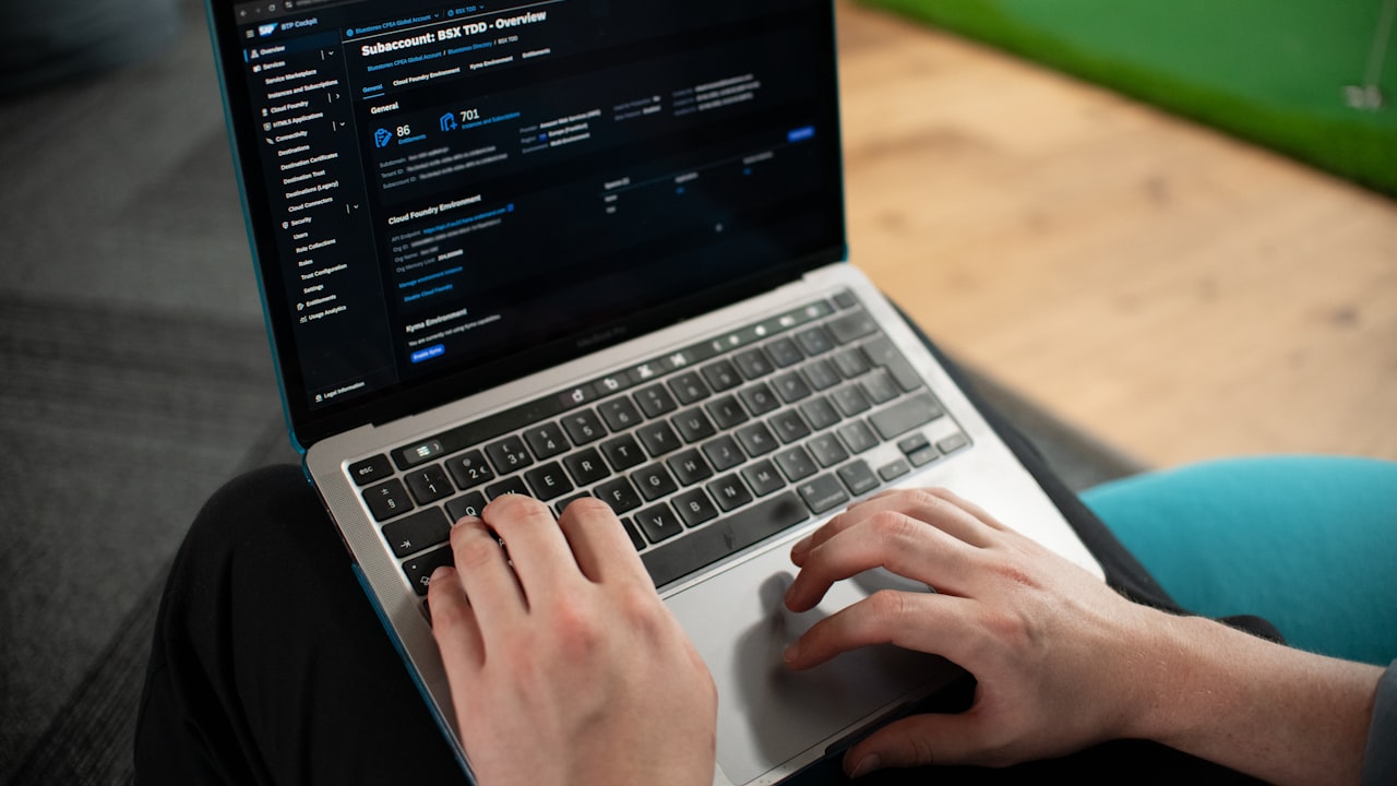 Hands typing on a laptop computer screen
