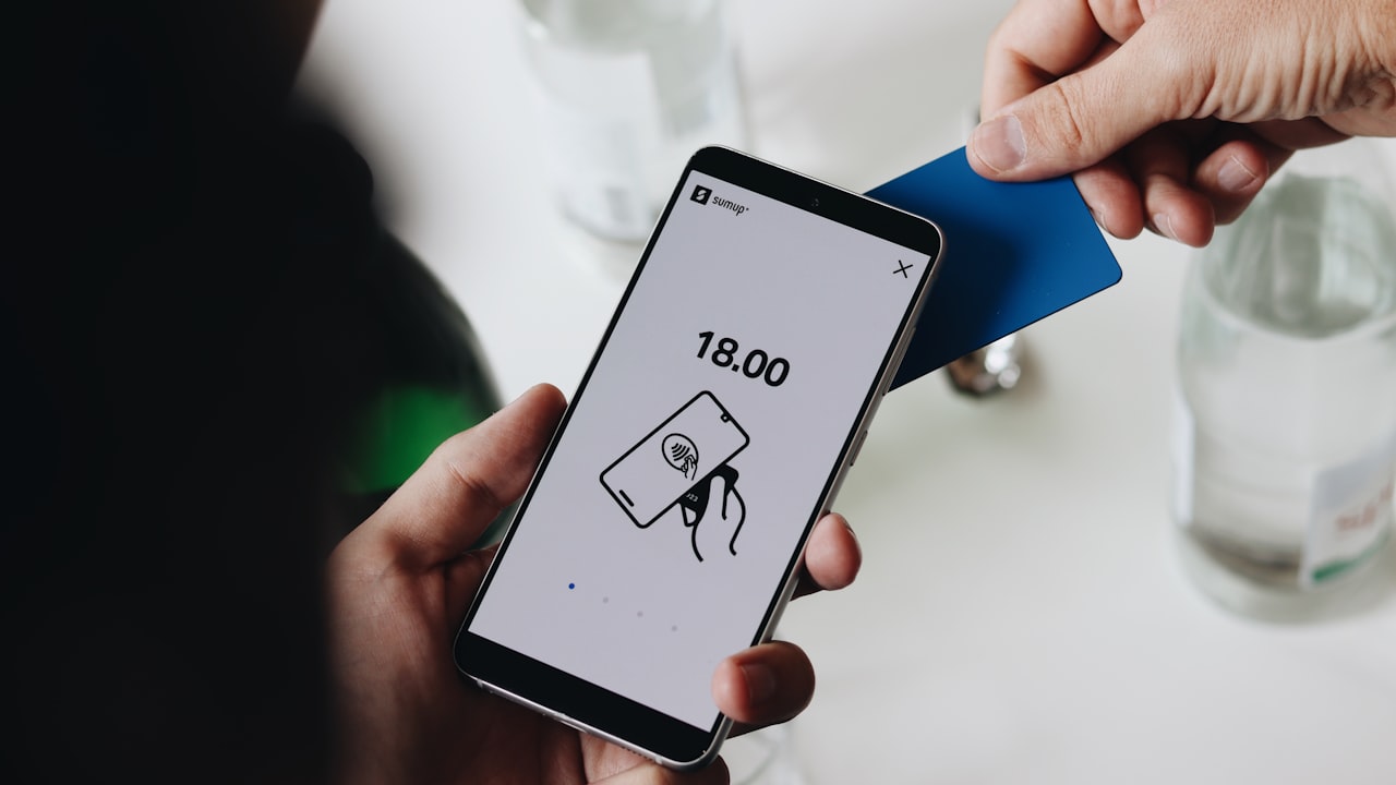 A person holding a cell phone in their hand