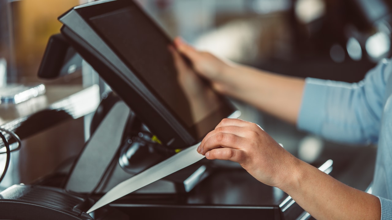 a person is using a tablet on a conveyor belt