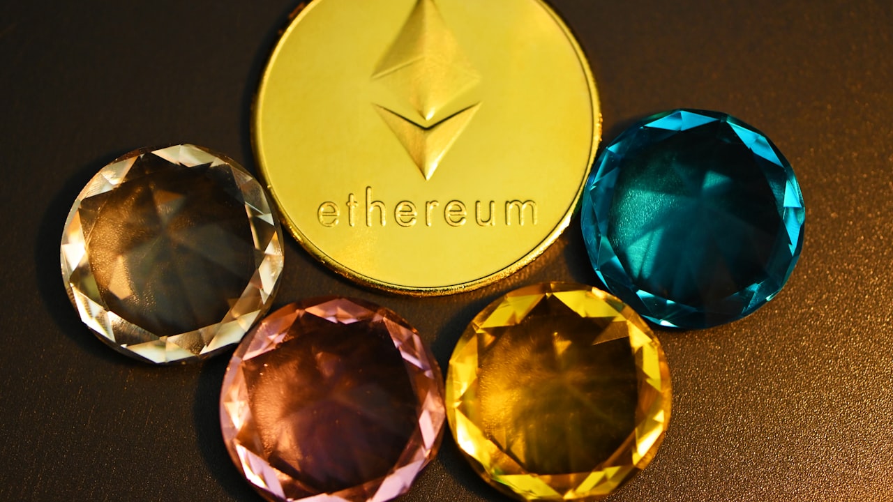 three different colored diamonds next to a gold coin